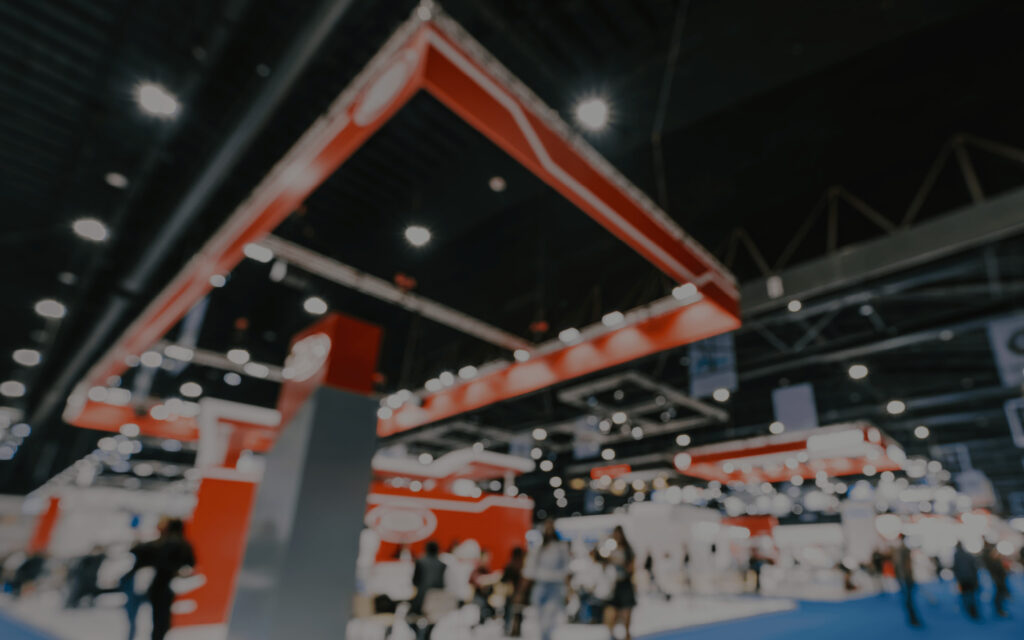 blurred convention banner red booth ceiling rafters