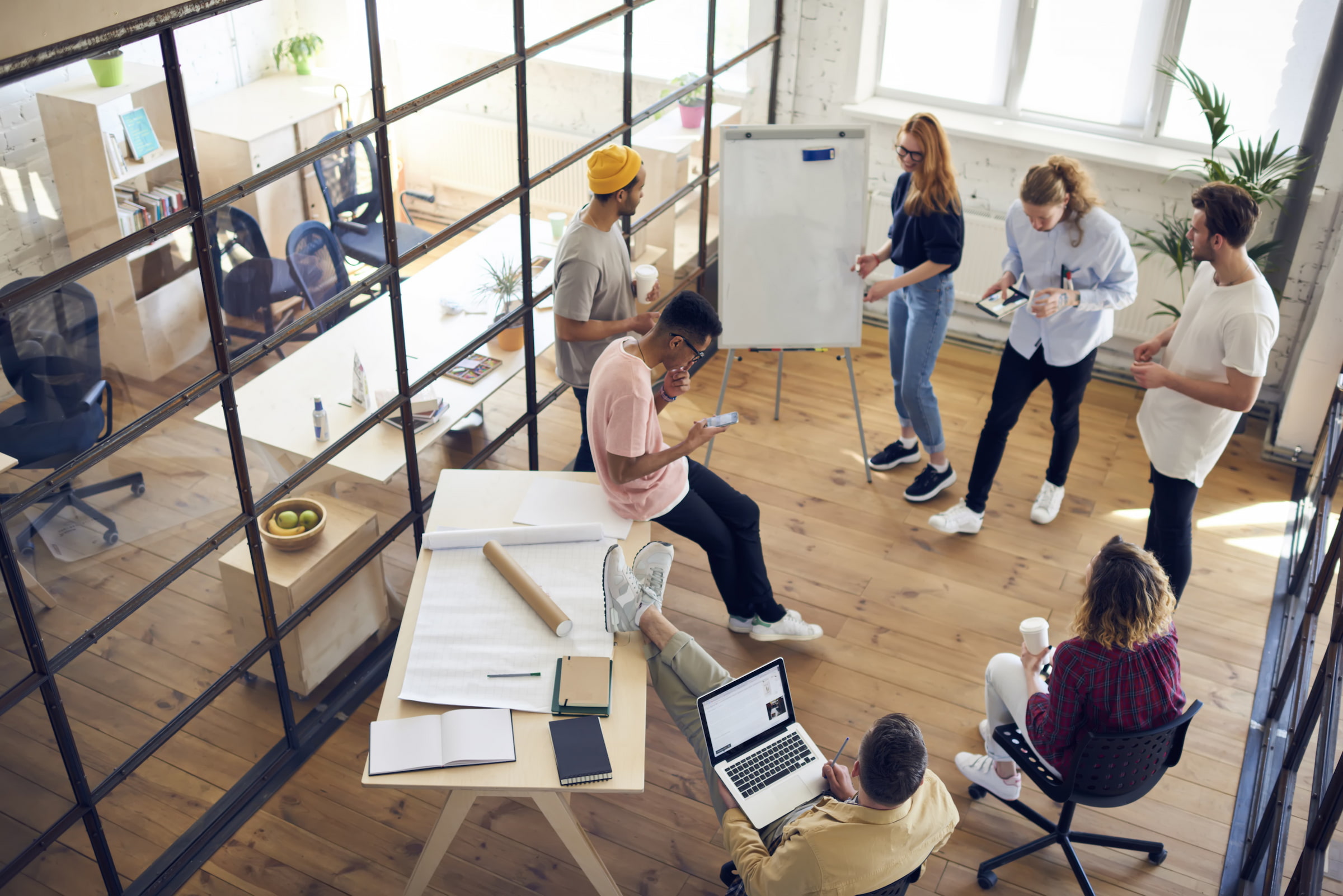 team of trendy employees in fashionable meeting room