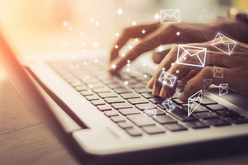 hands using laptop to send digital emails