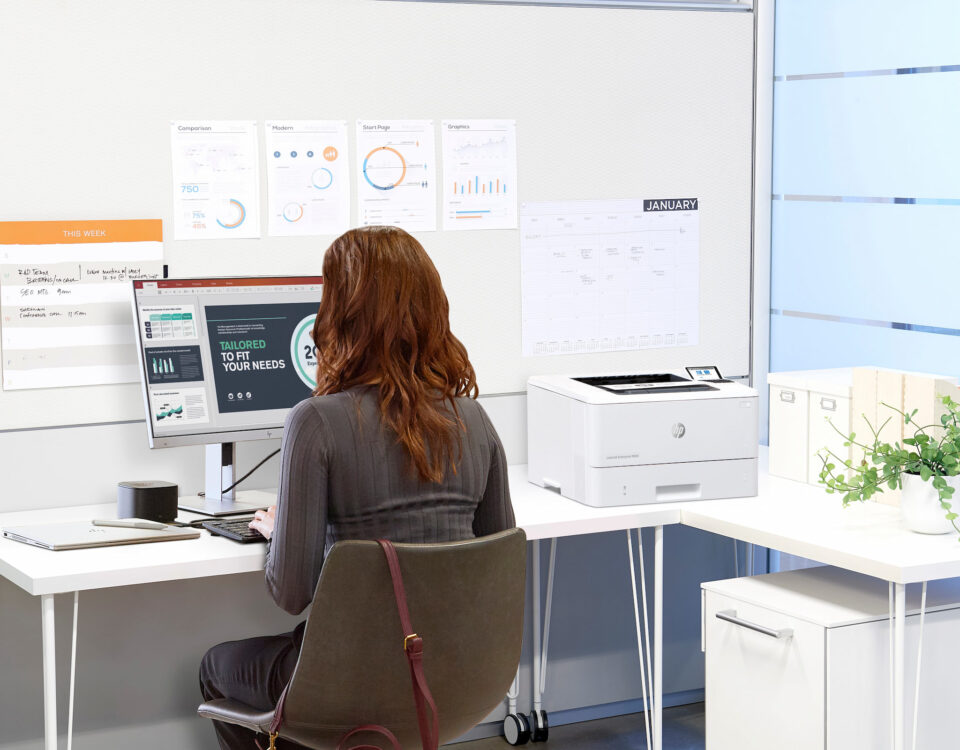 woman in white office designing marketing documents HP office printer