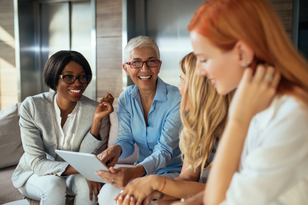 four diverse women workplace elevators lobby