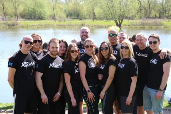 Team Apogee at Thomas Cook Dragon Boat Race Event in front of lake