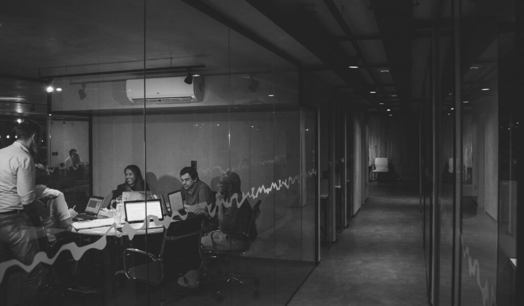black white film grain office people on laptops
