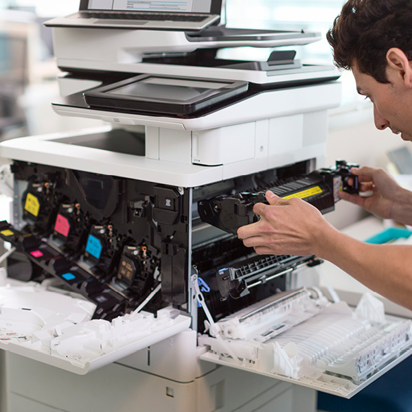 man fixing office printer