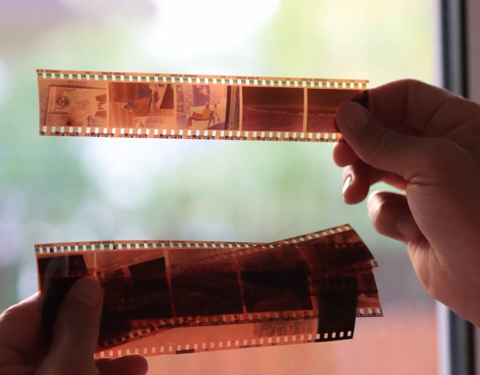 anaolog-photography-on-filmstrip-hands-holding-microfilm