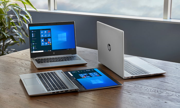 hp laptops on wood office table imaging services